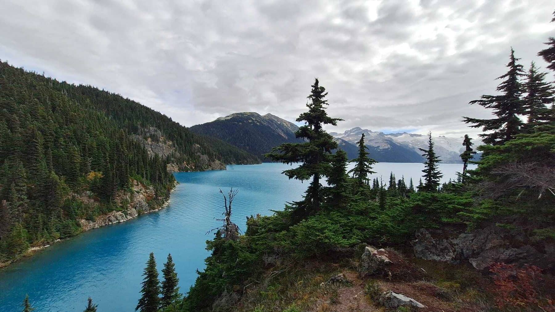 Garibaldi Lake, turquoise and still, with snow on the peaks behind it