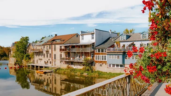 The limestone buildings of Elora village reflected in the Grand River