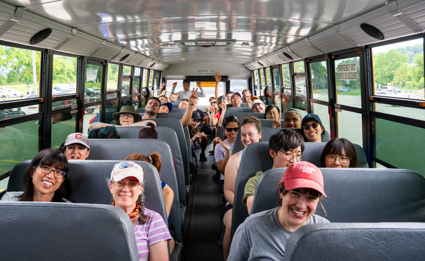 Smiling Parkbus passengers on the bus, on the way to the park